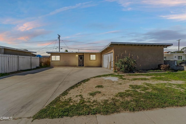 view of front of property with fence and stucco siding