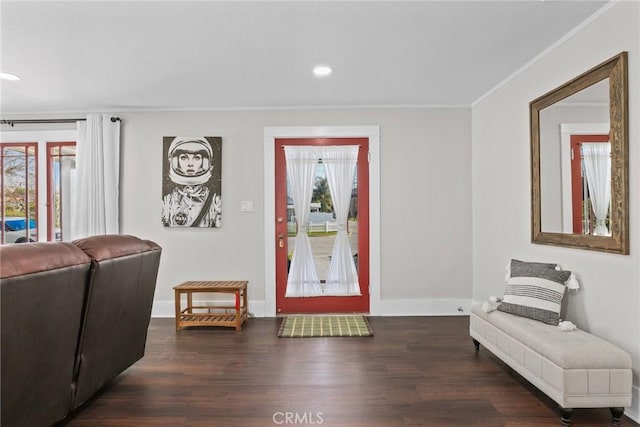 entryway with recessed lighting, crown molding, baseboards, and wood finished floors