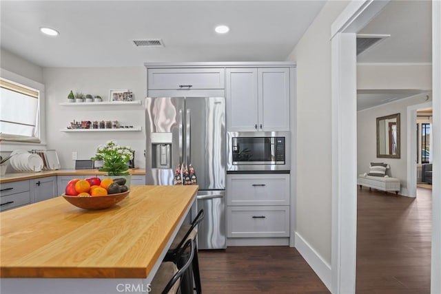 kitchen with recessed lighting, butcher block counters, visible vents, appliances with stainless steel finishes, and dark wood-style floors