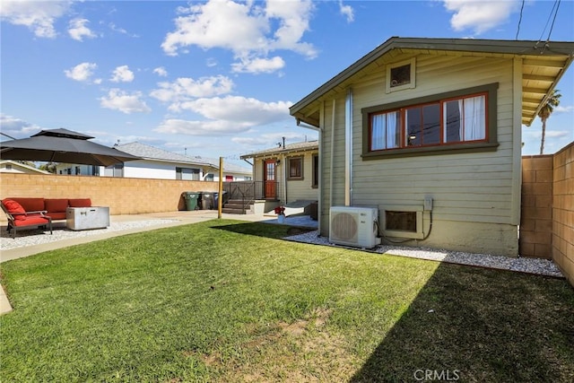 rear view of property featuring ac unit, a patio area, a fenced backyard, and a yard