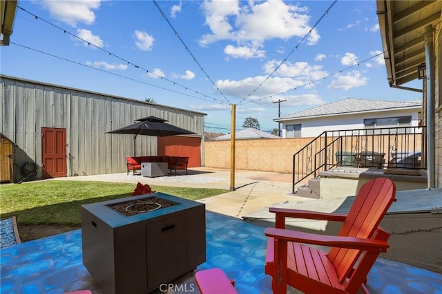 view of patio / terrace featuring a fenced backyard and a fire pit