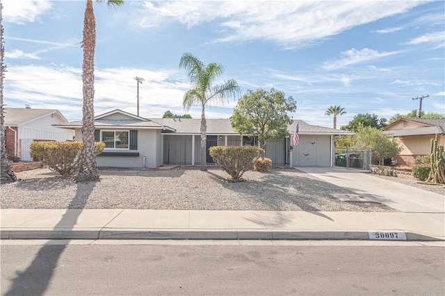 ranch-style house with concrete driveway and stucco siding