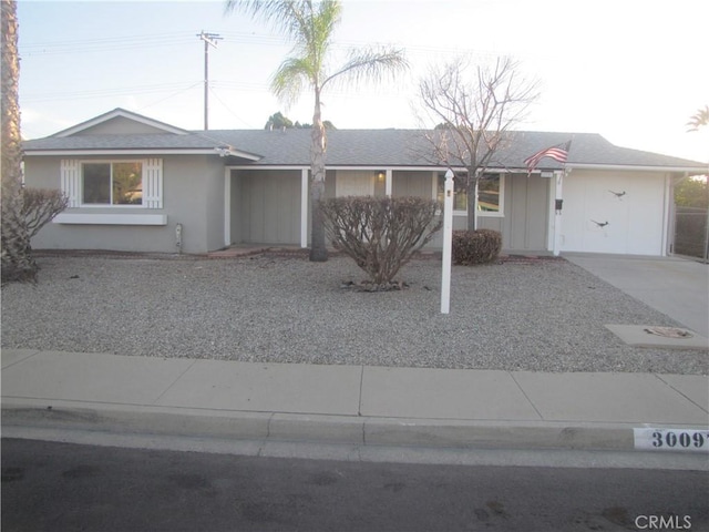 ranch-style house featuring stucco siding