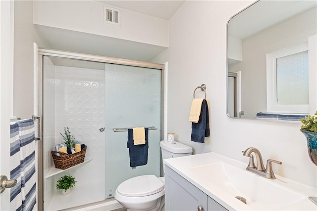 full bath with visible vents, a shower stall, toilet, and vanity