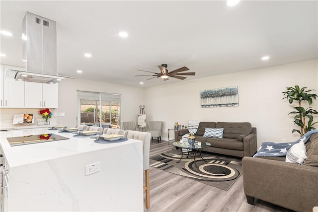 living area featuring recessed lighting, ceiling fan, and light wood finished floors