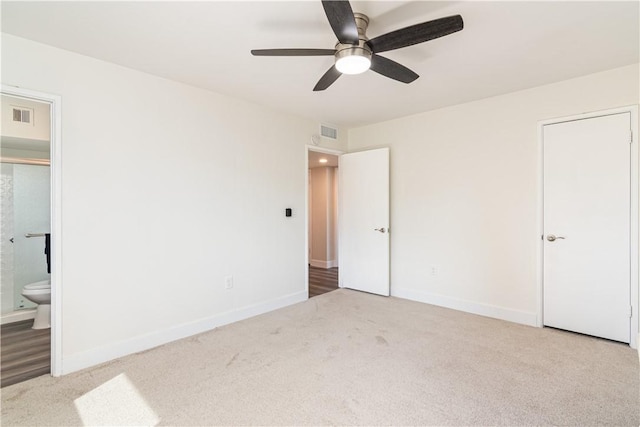 unfurnished bedroom with carpet, visible vents, and baseboards