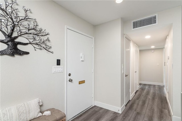 interior space featuring baseboards, visible vents, dark wood-type flooring, and recessed lighting