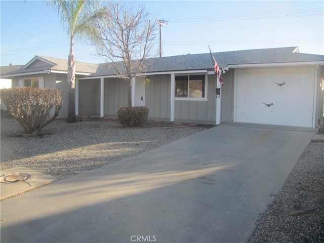 ranch-style house featuring driveway and board and batten siding