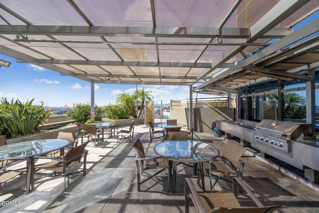 view of patio featuring outdoor dining area, a pergola, and area for grilling