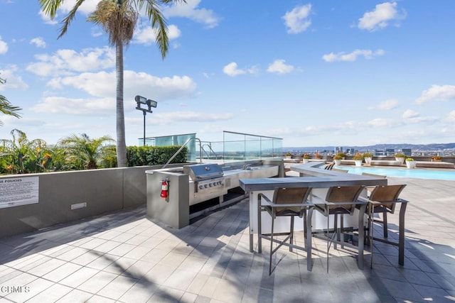 view of patio with a pool and outdoor dry bar