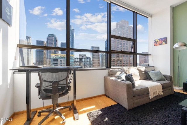 office area with a view of city, wood finished floors, and baseboards