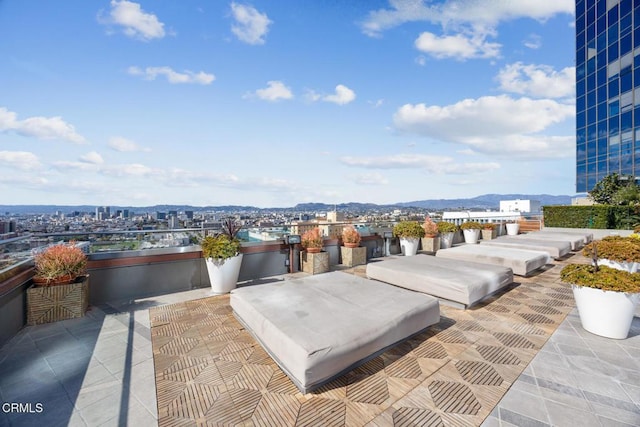 view of patio / terrace featuring a mountain view and a city view