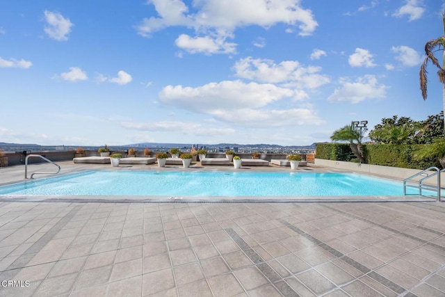 outdoor pool featuring a patio