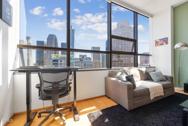 1100 Wilshire Blvd Unit 1808, Los Angeles, CA 90017 - living room with a view of skyline, wood finished floors, and a wall of windows