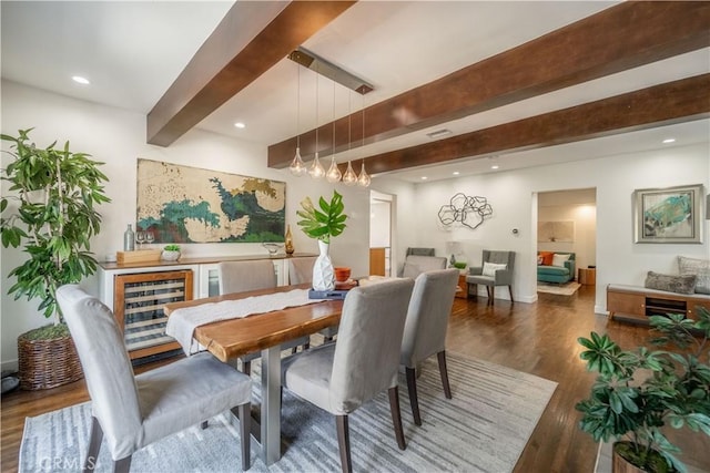 dining room with beam ceiling, recessed lighting, visible vents, wood finished floors, and beverage cooler