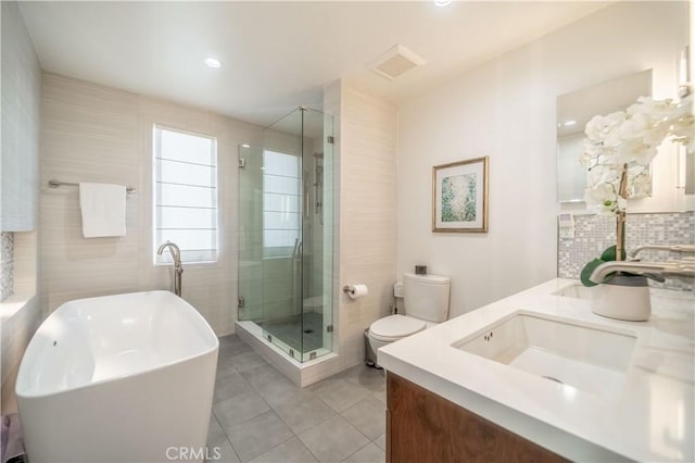 full bath with double vanity, a sink, toilet, and a shower stall