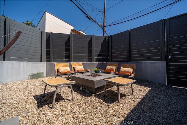 view of patio / terrace featuring a fire pit and fence