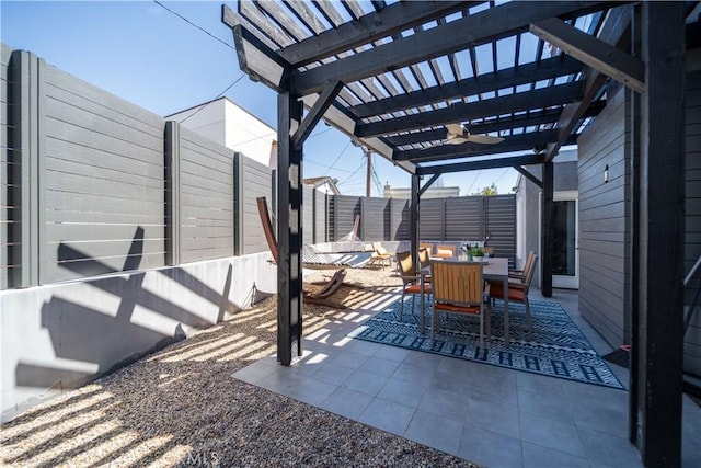 view of patio / terrace with outdoor dining area, a fenced backyard, and a pergola