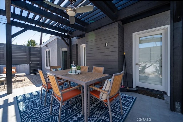 view of patio / terrace with outdoor dining area, a ceiling fan, and a pergola