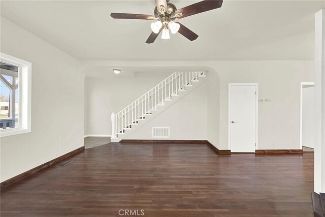 1495 S S, Corning, CA 96021 - unfurnished living room with wood finished floors, stairway, arched walkways, and visible vents