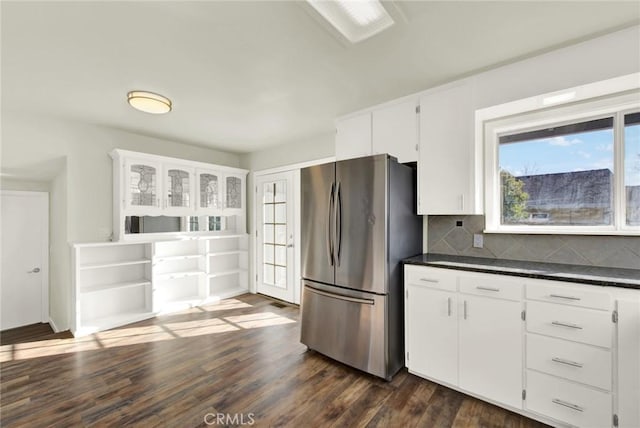 1495 S S, Corning, CA 96021 - kitchen with dark countertops, tasteful backsplash, freestanding refrigerator, white cabinetry, and dark wood-style flooring
