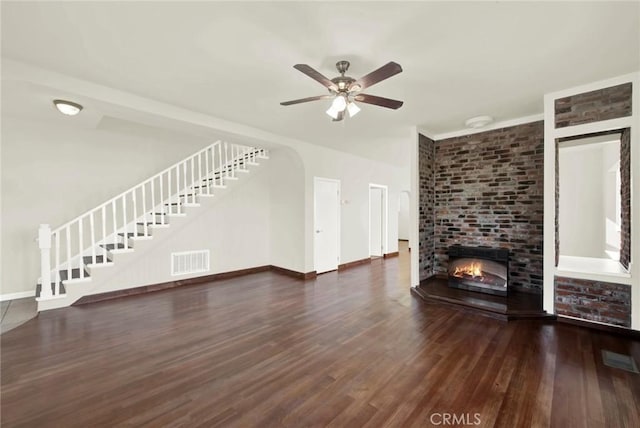1495 S S, Corning, CA 96021 - unfurnished living room with stairs, visible vents, wood finished floors, and a fireplace