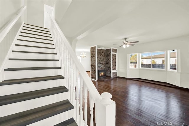 1495 S S, Corning, CA 96021 - stairway featuring ceiling fan with notable chandelier, a fireplace, and wood finished floors