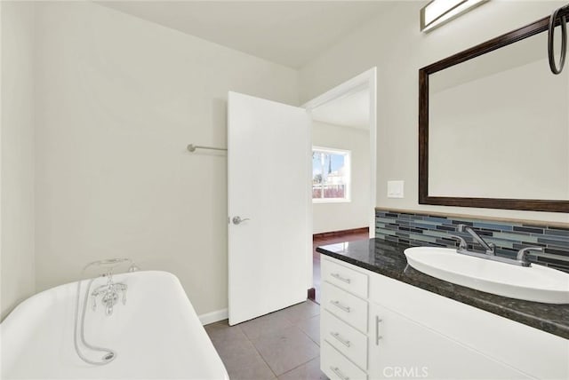1495 S S, Corning, CA 96021 - bathroom featuring vanity, baseboards, a freestanding bath, tile patterned flooring, and decorative backsplash