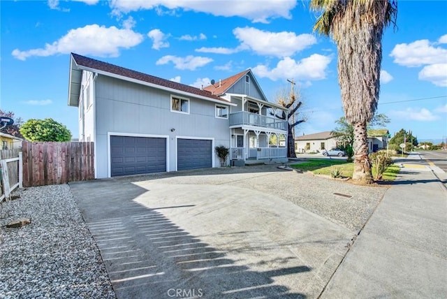 1495 S S, Corning, CA 96021 - view of front of home with a garage, a balcony, concrete driveway, and fence