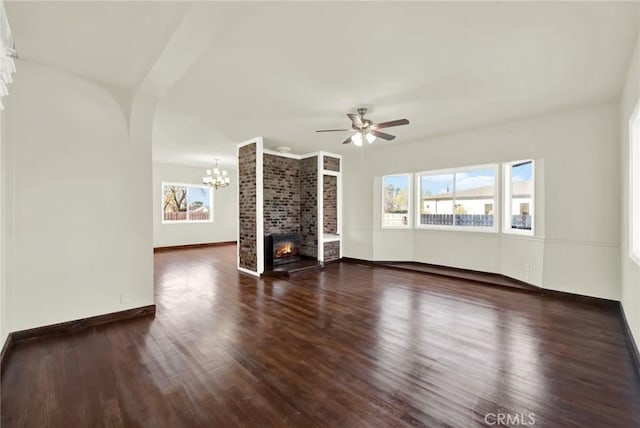 1495 S S, Corning, CA 96021 - unfurnished living room featuring baseboards, wood finished floors, a fireplace, and ceiling fan with notable chandelier