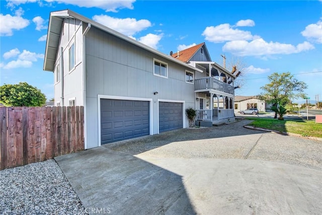 1495 S S, Corning, CA 96021 - view of front of property featuring a garage, a balcony, driveway, and fence