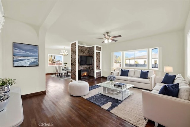 1495 S S, Corning, CA 96021 - living area with baseboards, wood finished floors, a fireplace, and ceiling fan with notable chandelier