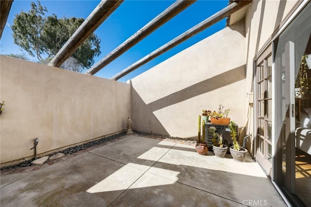 view of patio / terrace featuring fence