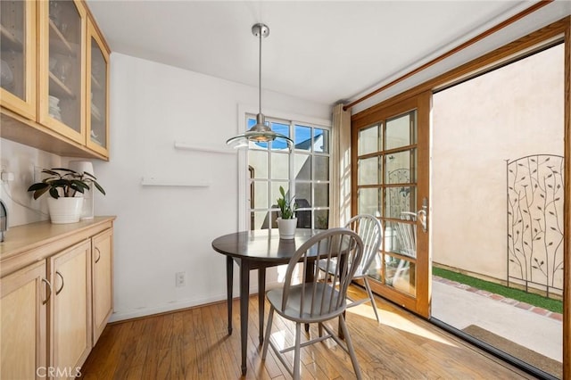 dining area with light wood-style floors and baseboards