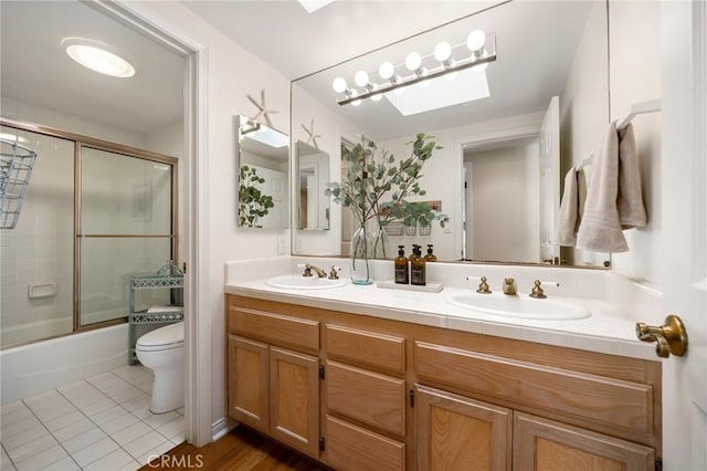 full bathroom featuring tile patterned flooring, a sink, toilet, and double vanity