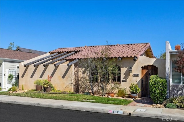 view of front of home with a tiled roof and stucco siding