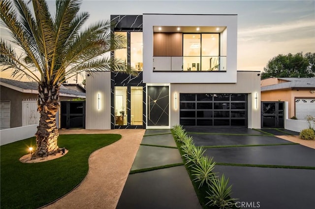 modern home featuring driveway and stucco siding