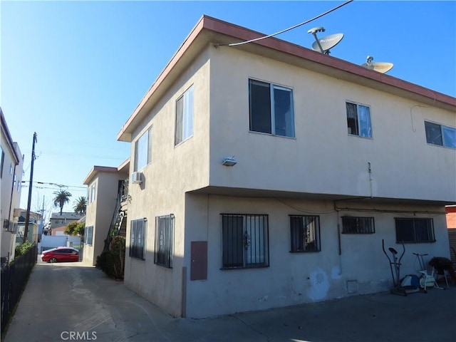 view of side of home featuring stucco siding