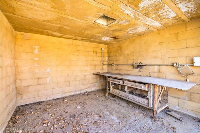 miscellaneous room with concrete block wall