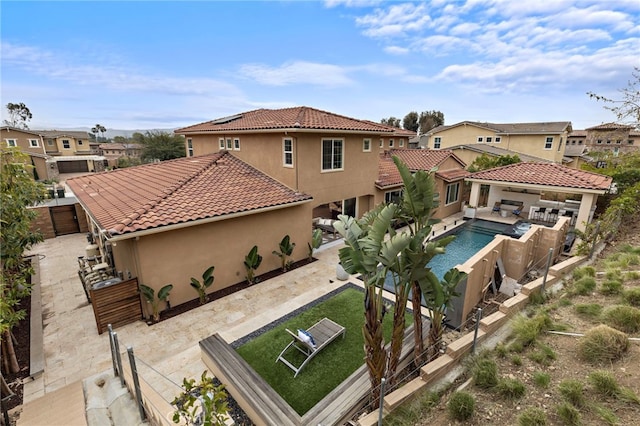 back of property featuring a patio, a yard, a fenced backyard, and stucco siding