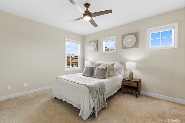 bedroom with baseboards, light carpet, and a ceiling fan