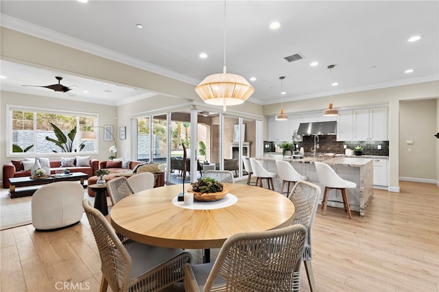 dining space featuring recessed lighting, visible vents, light wood-style floors, and ornamental molding