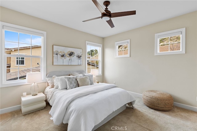 bedroom featuring carpet, baseboards, and ceiling fan