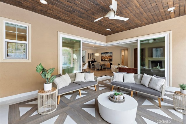 view of patio featuring an outdoor living space, outdoor dining area, and a ceiling fan