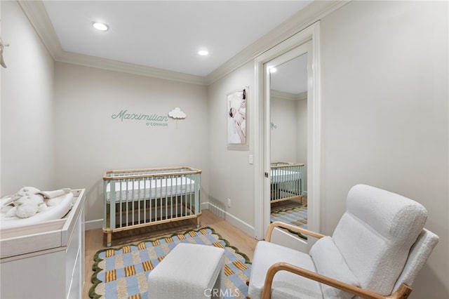 bedroom featuring recessed lighting, baseboards, wood finished floors, and crown molding