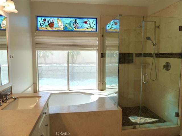 full bathroom featuring a stall shower, a bath, and vanity