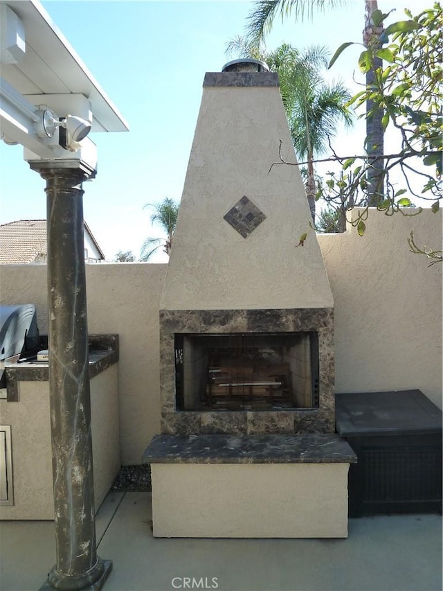 details with stone siding, exterior fireplace, and stucco siding