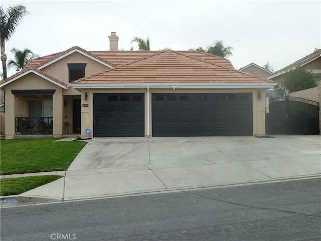 view of front of home featuring a chimney, stucco siding, concrete driveway, a gate, and a tiled roof