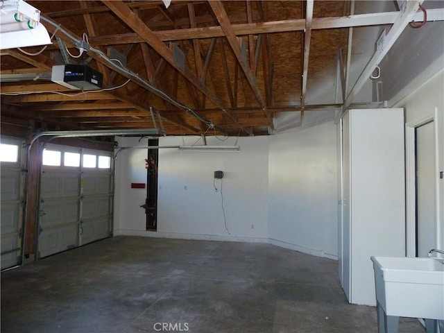 garage with a sink and a garage door opener