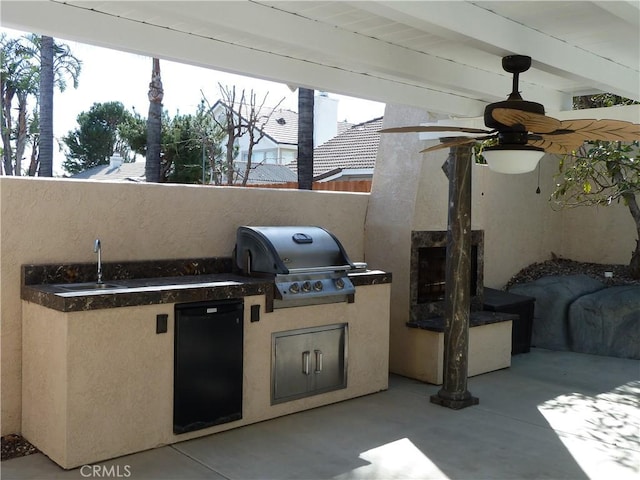 view of patio with exterior kitchen, a grill, and a sink